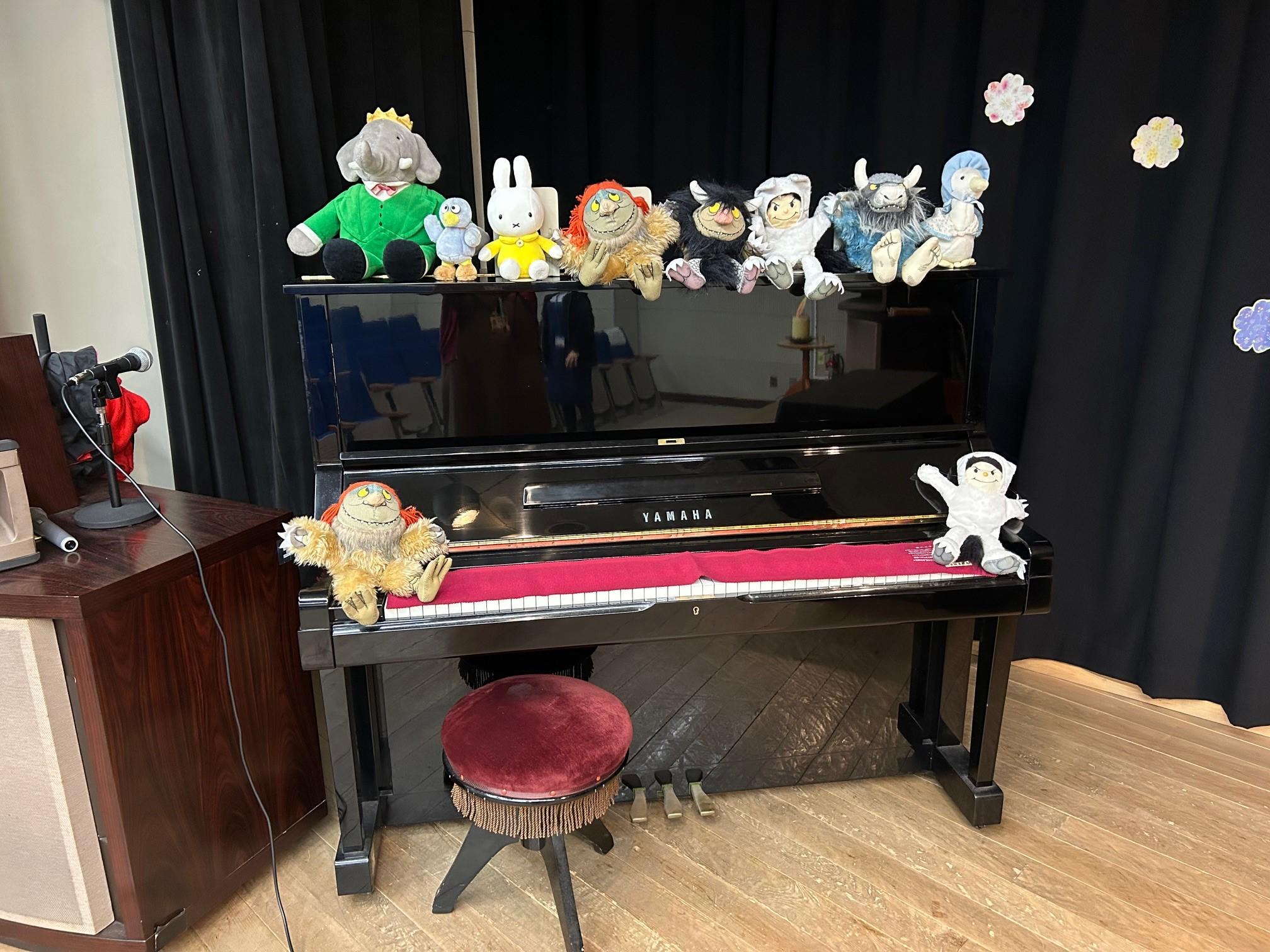 会場ステージのピアノの様子。絵本に登場するぬいぐるみがずらり。